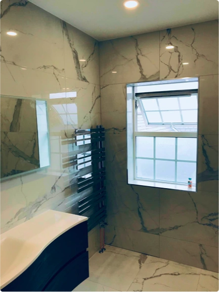 A bathroom featuring a polished marble floor and a modern sink, creating an elegant and clean aesthetic
